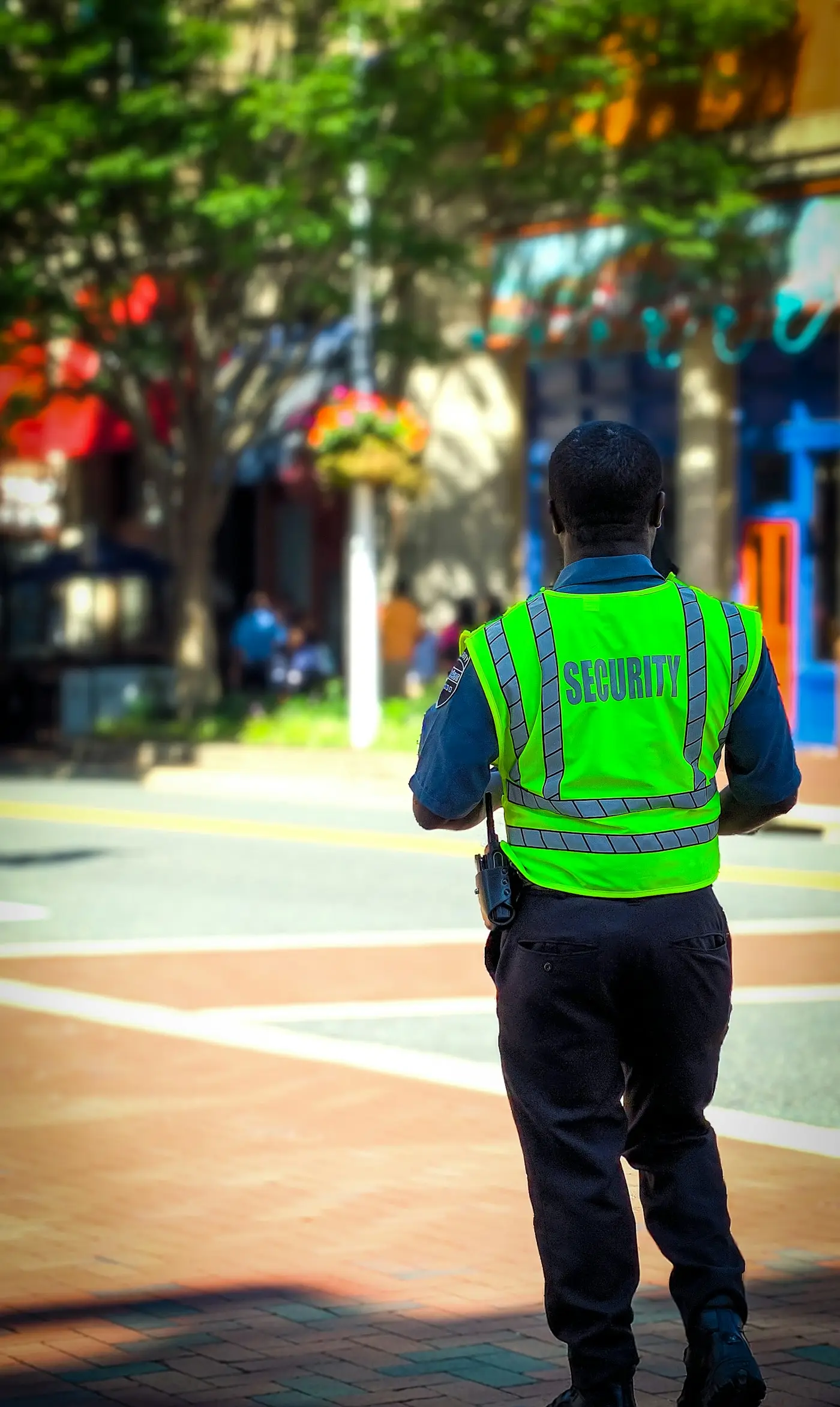 Security officer in a high-visibility vest on duty at a commercial site