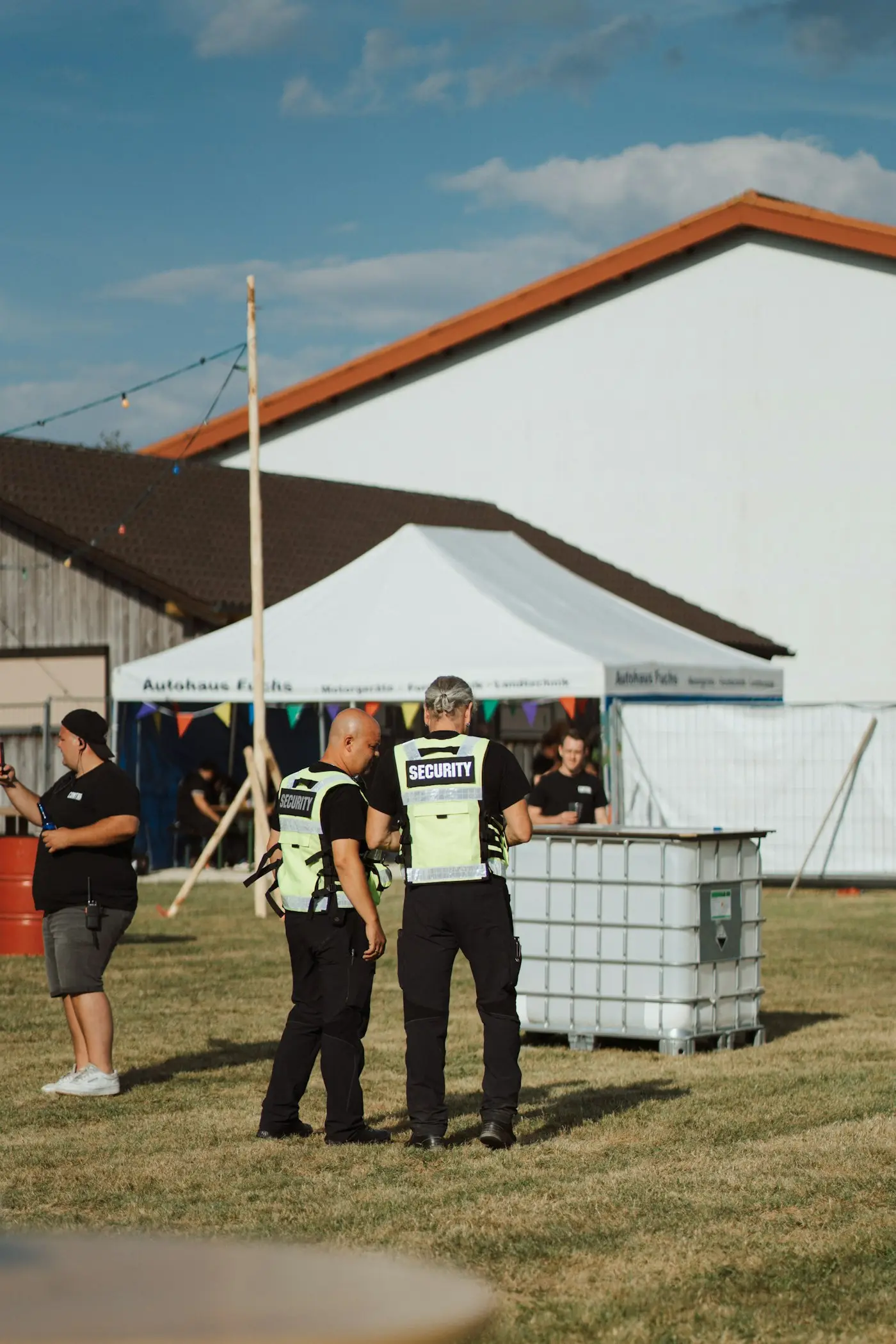 Security team in high-visibility vests briefing on site at an event